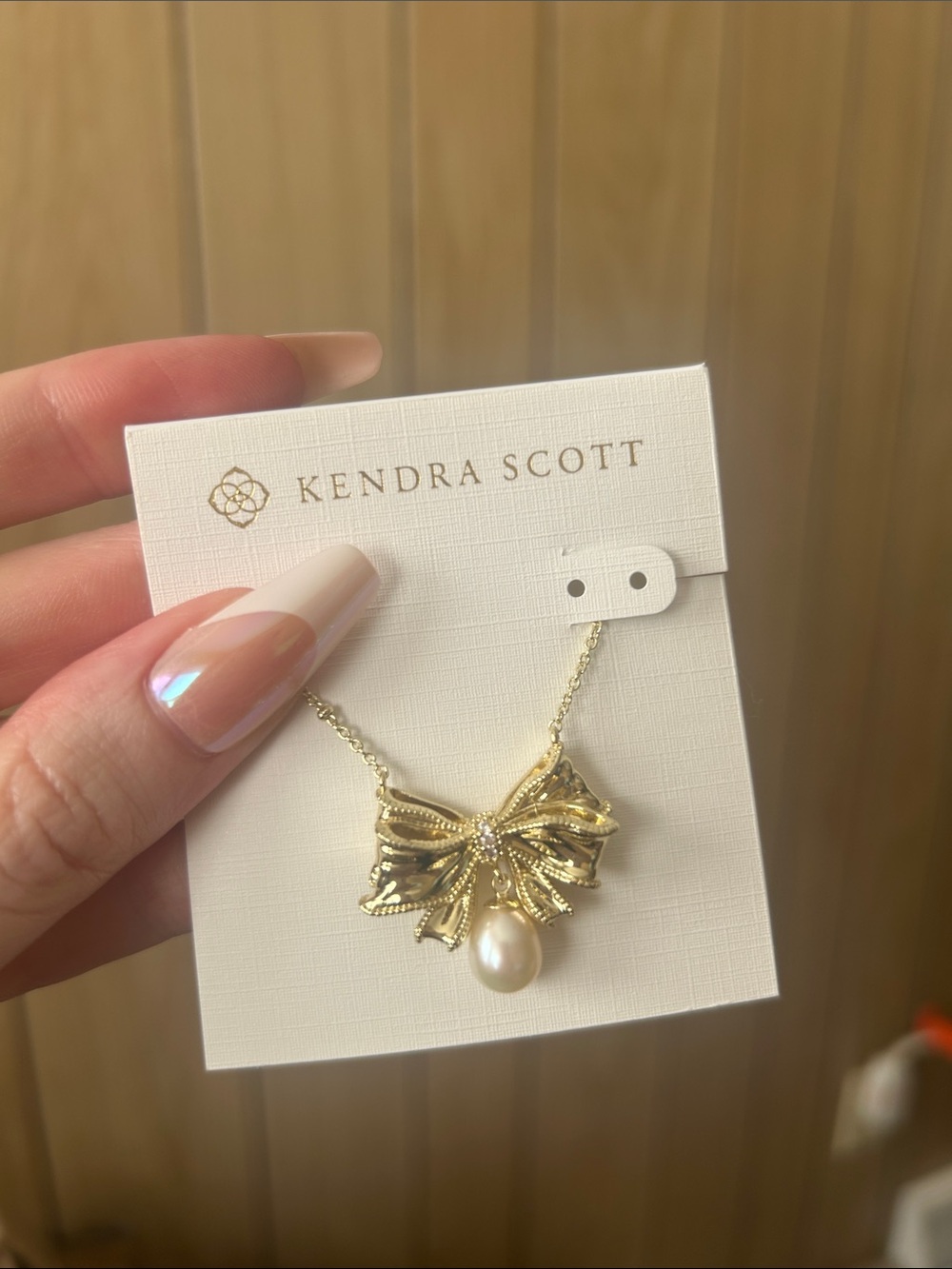 Kendra Scott gold bow and pearl necklace